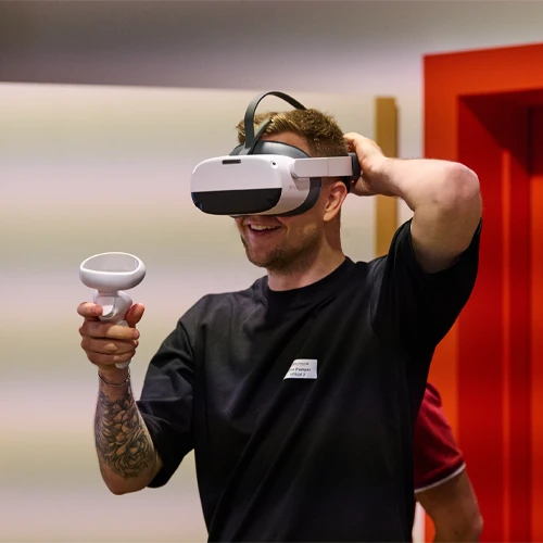 Ein Mann mit VR-Brille erkundet die digitalen VR-Arbeitswelten